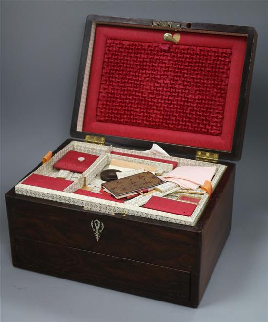 A Victorian rosewood rectangular work box, enclosing a fitted interior with a drawer in the base, the top inlaid